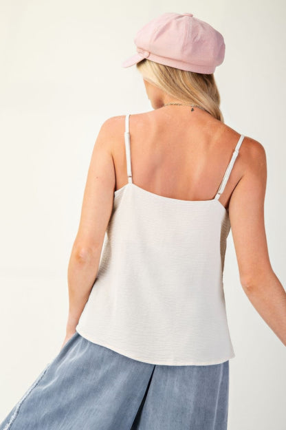 Laced Textured Poly Woven Camisole" a delicate and stylish camisole made from textured polyester fabric, featuring lace details for added elegance. It's a versatile piece suitable for layering or wearing on its own